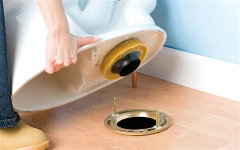 how to remove metal bracket under toilet|replace toilet flange under toilet.